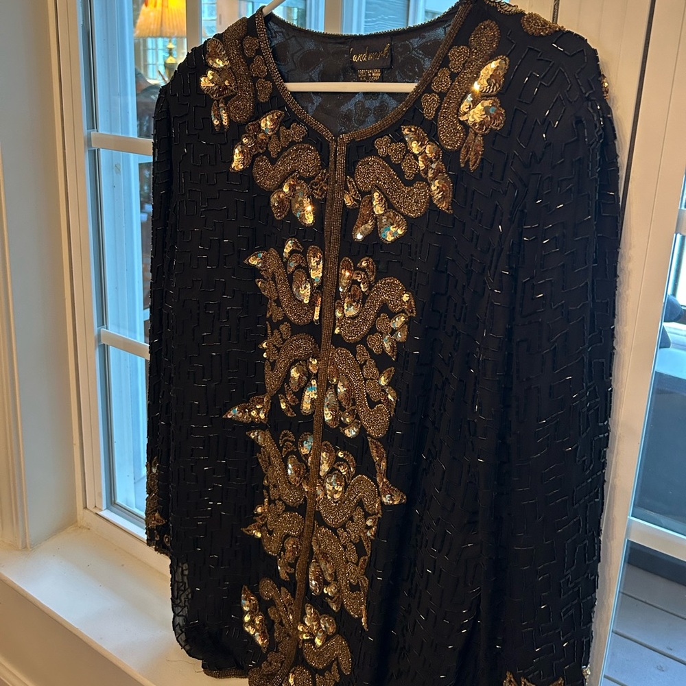 Women’s intricately gold and black heavily beaded jacket for evening wear.